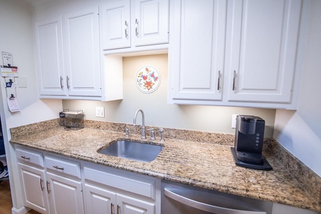 1610 Franklin Crossing Rd Unit 1610, Franklin, MA 02038 - kitchen featuring stainless steel dishwasher, a sink, white cabinets, and light stone counters
