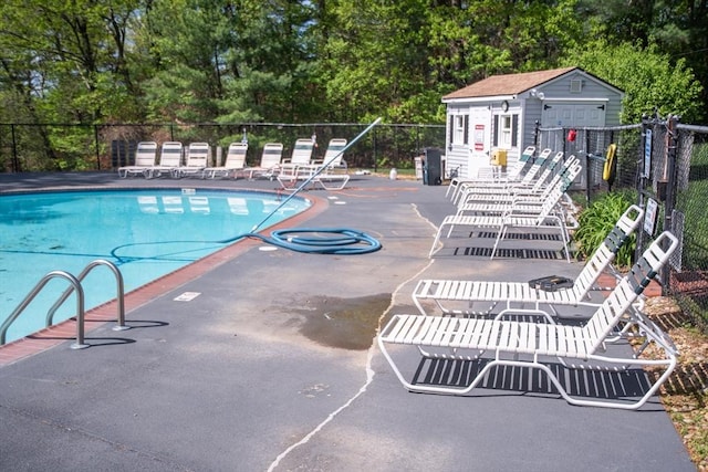 1610 Franklin Crossing Rd Unit 1610, Franklin, MA 02038 - community pool featuring view of scattered trees, a patio, and an outbuilding