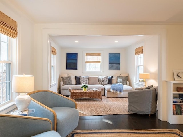 living room featuring recessed lighting, dark wood-type flooring, and ornamental molding