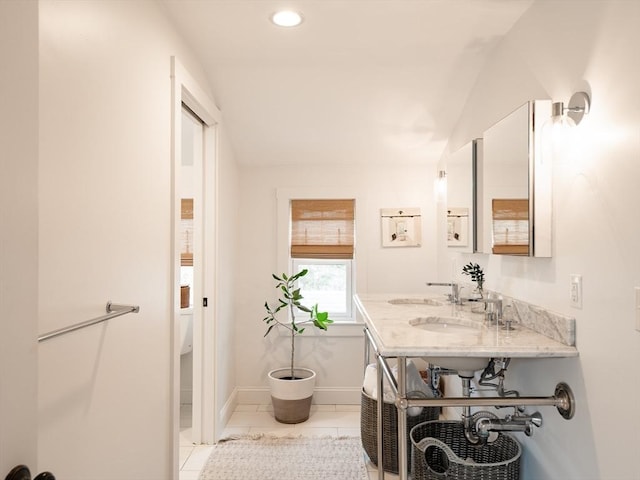 bathroom with tile patterned flooring, recessed lighting, baseboards, and a sink