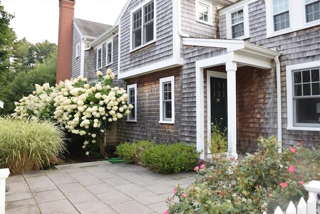 doorway to property with a chimney