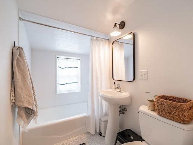 full bathroom featuring tile patterned floors, toilet, and shower / bath combination with curtain