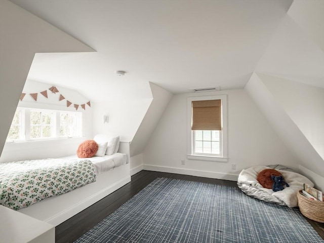 bedroom with baseboards, multiple windows, dark wood-style flooring, and vaulted ceiling