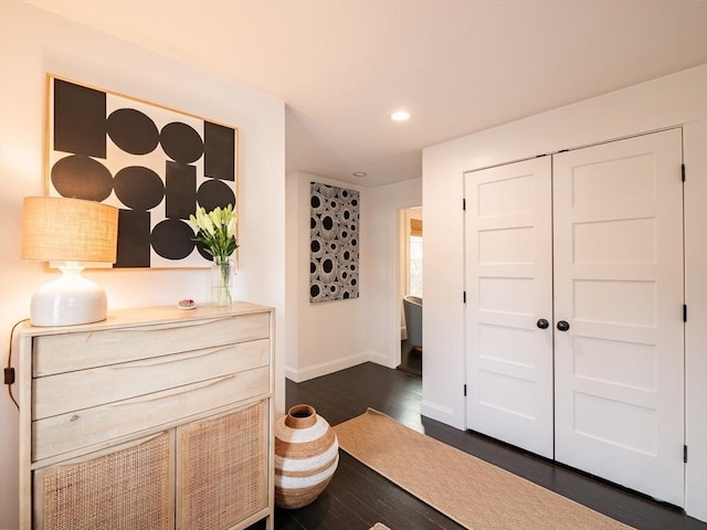 bedroom featuring dark wood-type flooring, recessed lighting, baseboards, and a closet