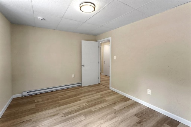 34 Worcester Rd, Charlton, MA 01507 - unfurnished room featuring baseboard heating, wood finished floors, a drop ceiling, baseboards, and a smoke detector
