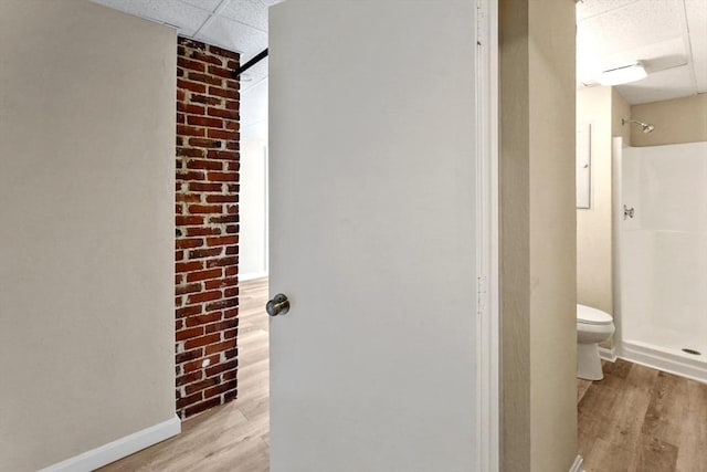 34 Worcester Rd, Charlton, MA 01507 - bathroom with a paneled ceiling, wood finished floors, toilet, baseboards, and a shower