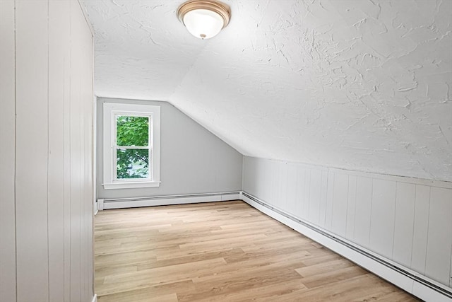 34 Worcester Rd, Charlton, MA 01507 - bonus room with a baseboard radiator, lofted ceiling, a textured ceiling, and light wood-style flooring