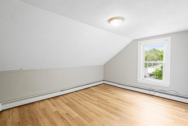 34 Worcester Rd, Charlton, MA 01507 - bonus room with wood finished floors, a textured ceiling, vaulted ceiling, and baseboard heating