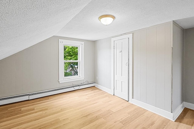 34 Worcester Rd, Charlton, MA 01507 - additional living space with a baseboard radiator, wood finished floors, a textured ceiling, baseboards, and vaulted ceiling