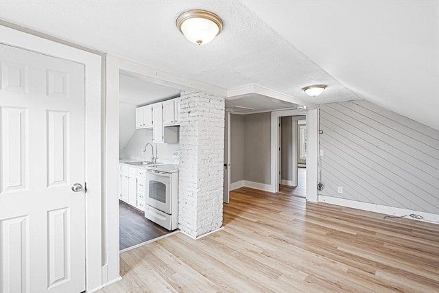34 Worcester Rd, Charlton, MA 01507 - kitchen featuring white electric range oven, baseboards, a sink, light wood-style floors, and light countertops