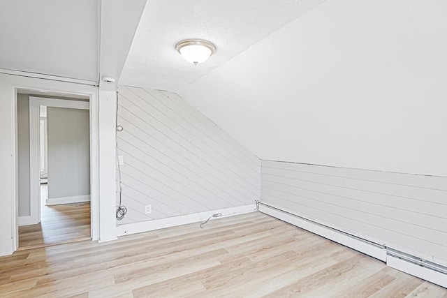 34 Worcester Rd, Charlton, MA 01507 - bonus room with baseboards, wood finished floors, a textured ceiling, lofted ceiling, and baseboard heating