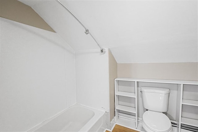 34 Worcester Rd, Charlton, MA 01507 - bathroom featuring toilet, a baseboard heating unit, shower / bath combination, wood finished floors, and vaulted ceiling