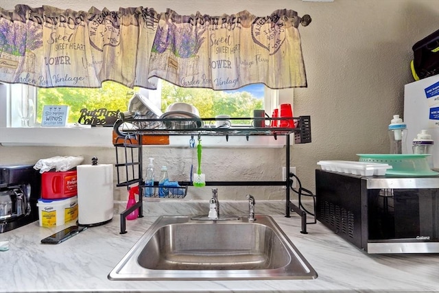 34 Worcester Rd, Charlton, MA 01507 - detailed view of stainless steel microwave, a sink, and a textured wall