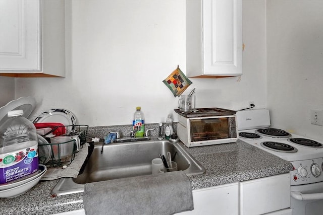 34 Worcester Rd, Charlton, MA 01507 - kitchen with white electric stove, white cabinets, and a sink