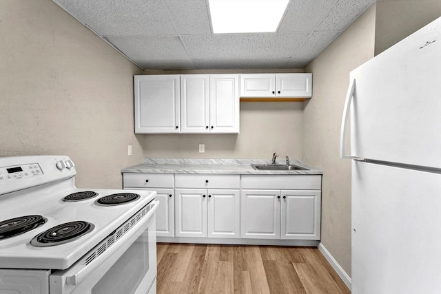 34 Worcester Rd, Charlton, MA 01507 - kitchen with white appliances, a sink, light wood-style flooring, white cabinets, and a drop ceiling