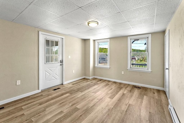 34 Worcester Rd, Charlton, MA 01507 - spare room featuring a baseboard heating unit, a paneled ceiling, light wood finished floors, and baseboards