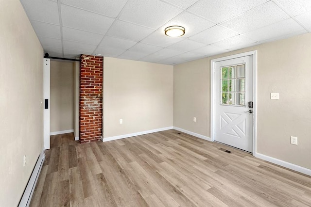 34 Worcester Rd, Charlton, MA 01507 - empty room with a baseboard radiator, a drop ceiling, light wood finished floors, and baseboards