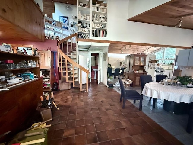 23 Partridge Hill Rd, Dudley, MA 01571 - living area with track lighting, stairway, dark tile patterned flooring, and a high ceiling
