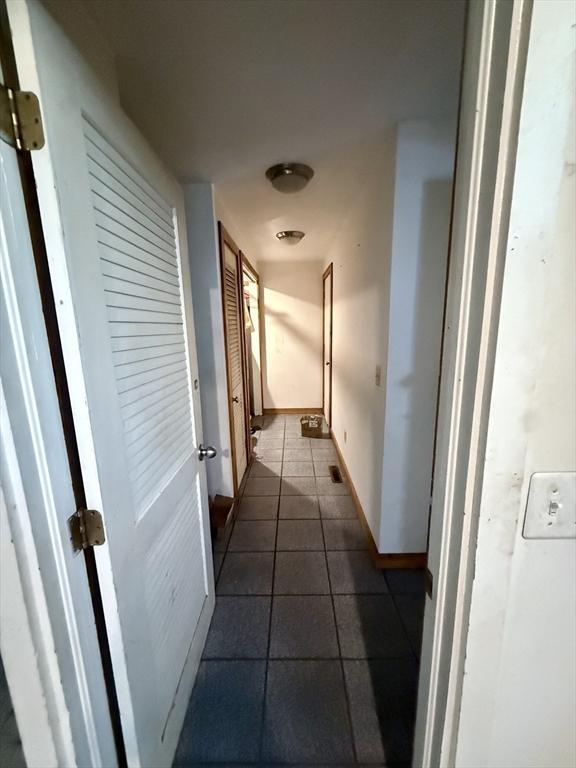 23 Partridge Hill Rd, Dudley, MA 01571 - hallway with dark tile patterned flooring and baseboards