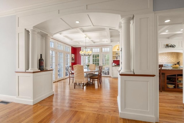 dining room with visible vents, coffered ceiling, and ornate columns