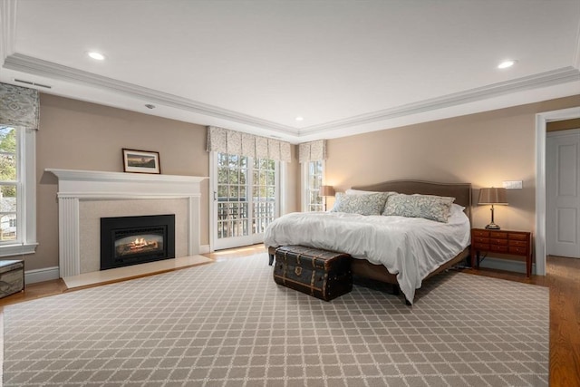 bedroom featuring recessed lighting, access to exterior, wood finished floors, and ornamental molding