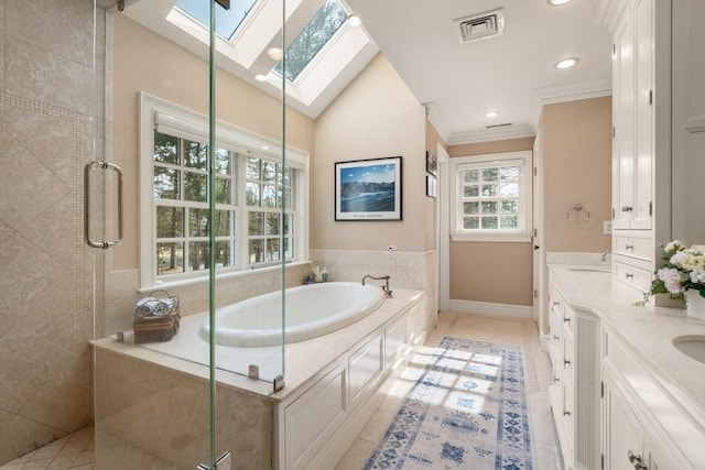 full bathroom with visible vents, a shower stall, ornamental molding, vaulted ceiling with skylight, and a bath