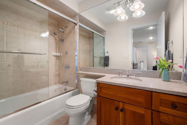 full bath featuring vanity, bath / shower combo with glass door, tile patterned floors, toilet, and a chandelier