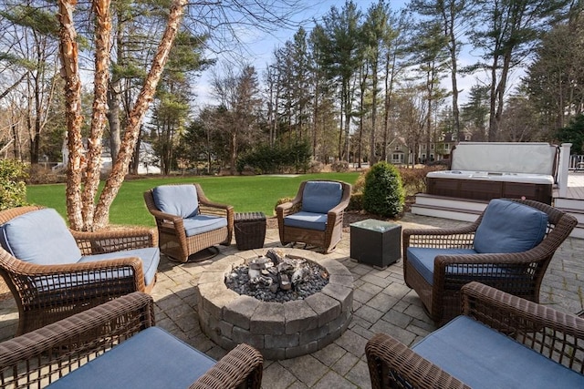 view of patio / terrace featuring an outdoor living space with a fire pit and a hot tub