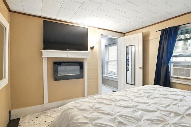 52 Harvard St, Chicopee, MA 01020 - bedroom featuring crown molding, a glass covered fireplace, and cooling unit
