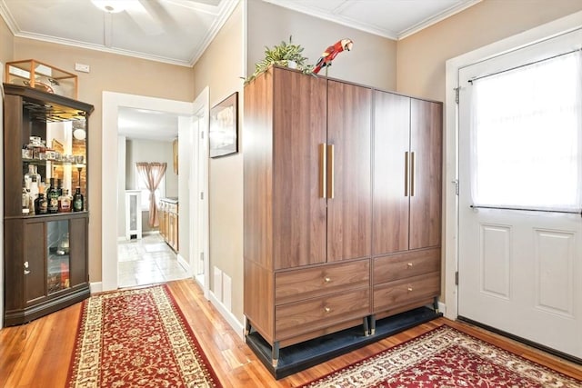 52 Harvard St, Chicopee, MA 01020 - foyer with light wood-type flooring, ornamental molding, and a dry bar