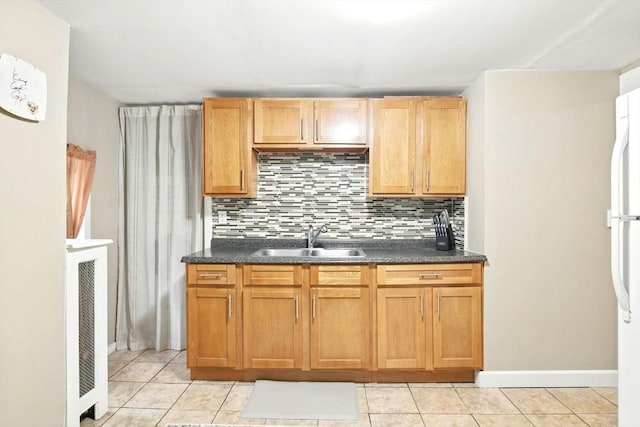 52 Harvard St, Chicopee, MA 01020 - kitchen with a sink, decorative backsplash, light tile patterned floors, and dark countertops