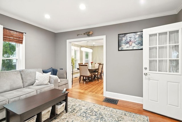 52 Harvard St, Chicopee, MA 01020 - living area with ornamental molding, light wood-style flooring, baseboards, and recessed lighting