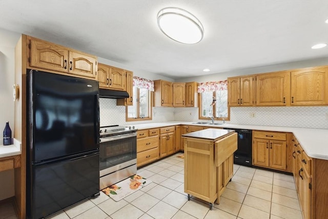 kitchen featuring black appliances, under cabinet range hood, a sink, a center island, and light countertops