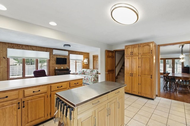 kitchen featuring open floor plan, an AC wall unit, and light tile patterned flooring