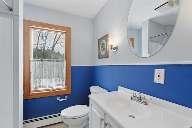 bathroom featuring visible vents, baseboard heating, vanity, and toilet