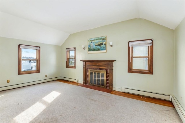 unfurnished living room featuring vaulted ceiling, a brick fireplace, and a baseboard radiator