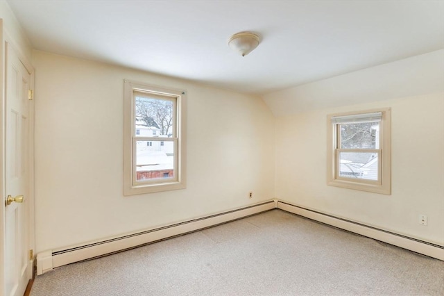 empty room with carpet, a baseboard radiator, and lofted ceiling