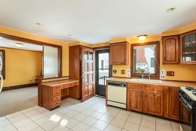 kitchen featuring white dishwasher, sink, light colored carpet, and range with gas cooktop