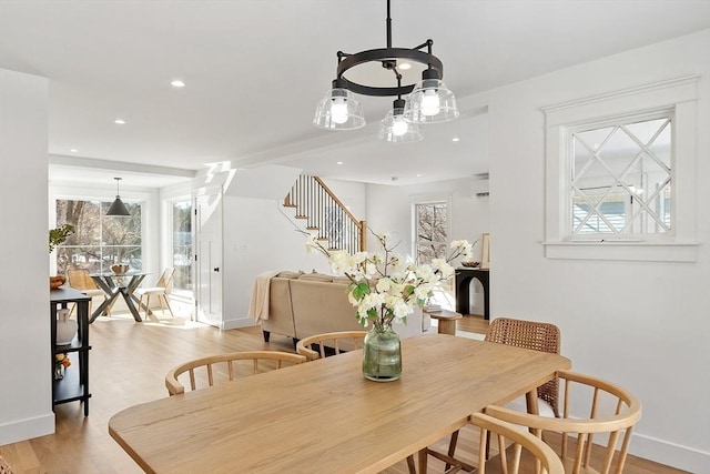 dining space featuring recessed lighting, light wood-style flooring, baseboards, and stairs