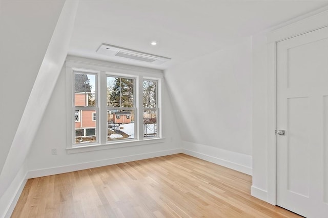 bonus room featuring light wood-style floors, visible vents, and baseboards