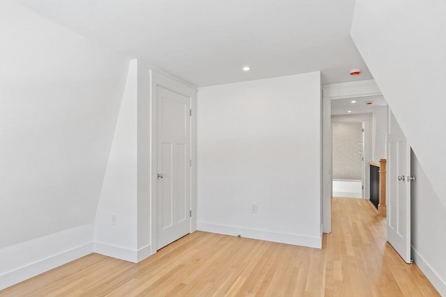 spare room with recessed lighting, light wood-style flooring, and baseboards