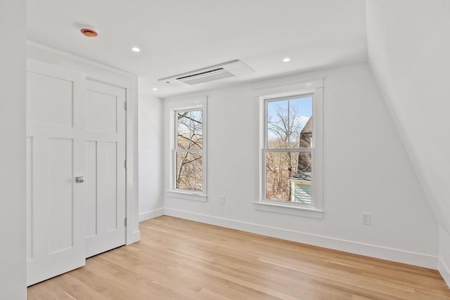 additional living space with recessed lighting, light wood-type flooring, visible vents, and baseboards