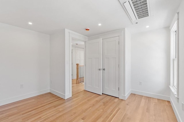 unfurnished bedroom featuring light wood finished floors, visible vents, and baseboards