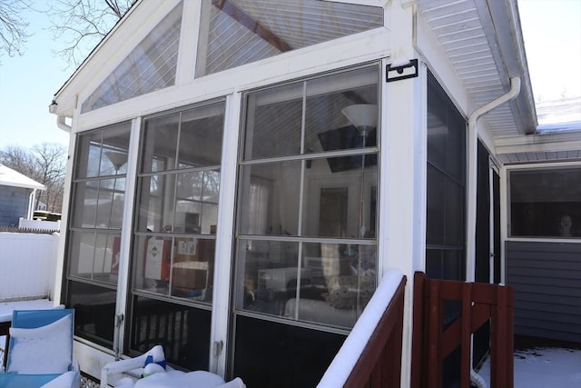 snow covered property featuring a sunroom