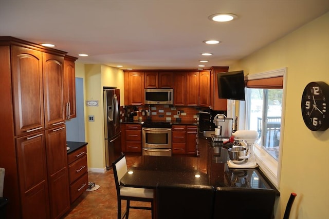 kitchen featuring stainless steel appliances, decorative backsplash, and dark tile patterned floors