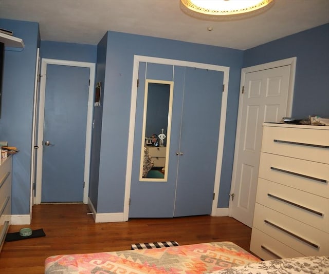 unfurnished bedroom with dark wood-type flooring