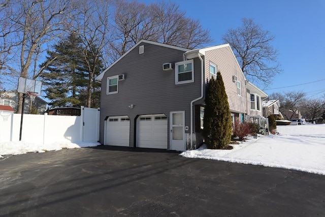 snow covered property featuring a garage