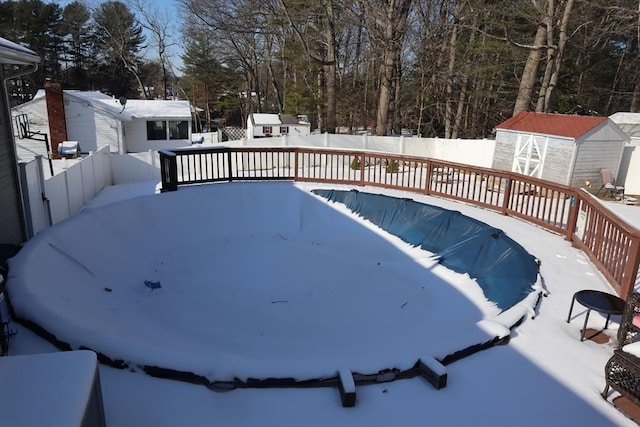 exterior space with a swimming pool side deck and a storage shed