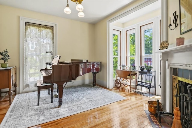 33 Grove St, Merrimac, MA 01860 - sitting room featuring wood-type flooring, a chandelier, and a tiled fireplace