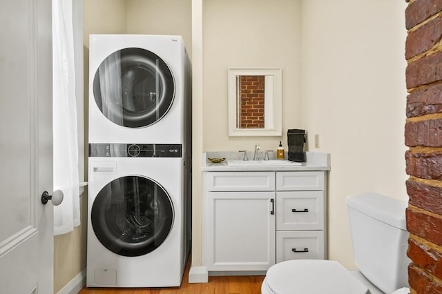 33 Grove St, Merrimac, MA 01860 - laundry area with stacked washer / dryer and light wood finished floors